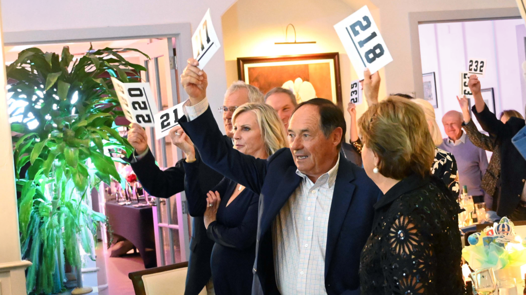 Attendees bidding at the live auction